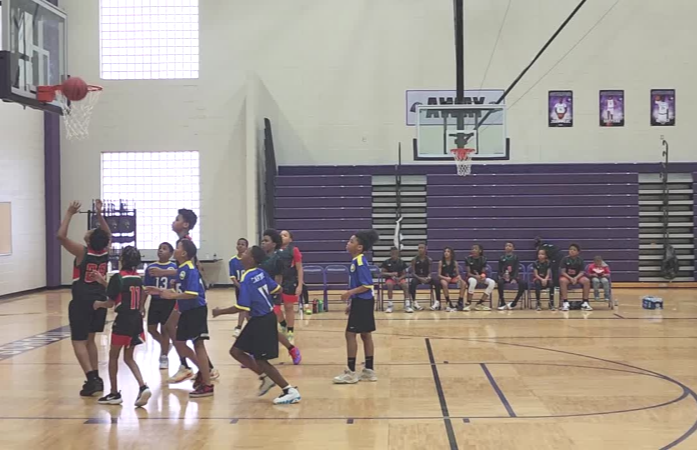  Students in uniforms playing basketball